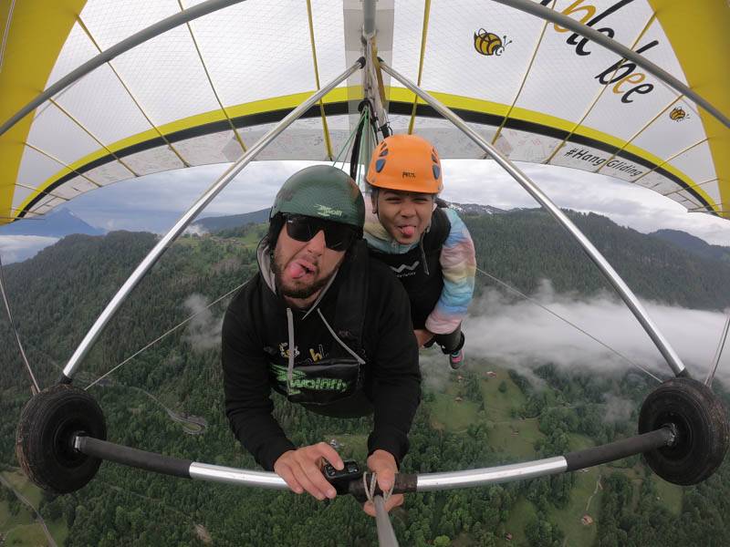 Exciting action selfie while hang gliding over the scenic landscapes of Interlaken.
